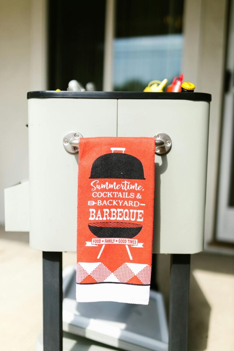 Bright outdoor setup featuring a barbecue with a festive towel. Perfect for summer gatherings.